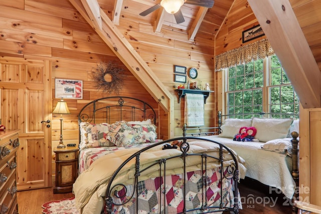 bedroom with lofted ceiling with beams, wood ceiling, wood walls, and wood-type flooring