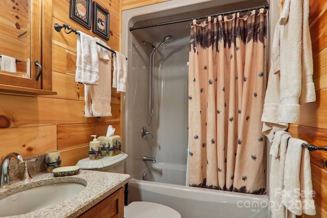 full bathroom with toilet, vanity, shower / tub combo with curtain, and wooden walls