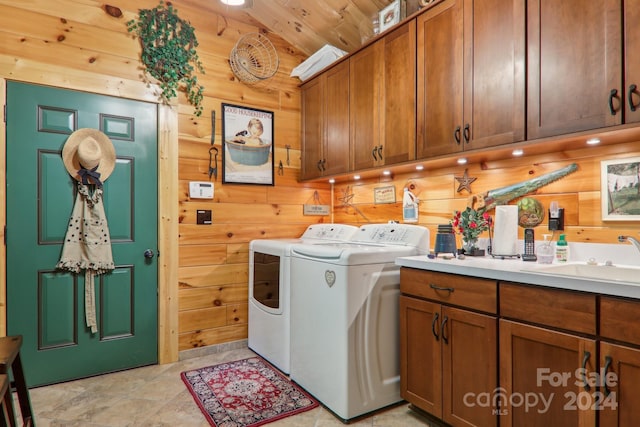 laundry area featuring washer and dryer, cabinets, wooden walls, sink, and wooden ceiling