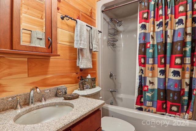 full bathroom featuring sink, toilet, wood walls, and shower / bath combo