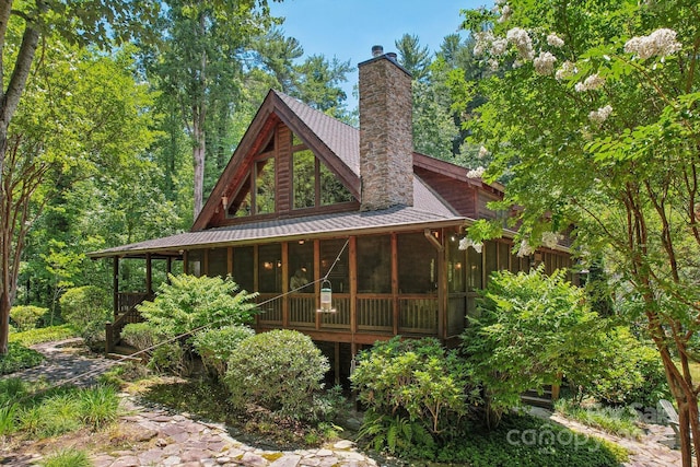 back of property with a sunroom