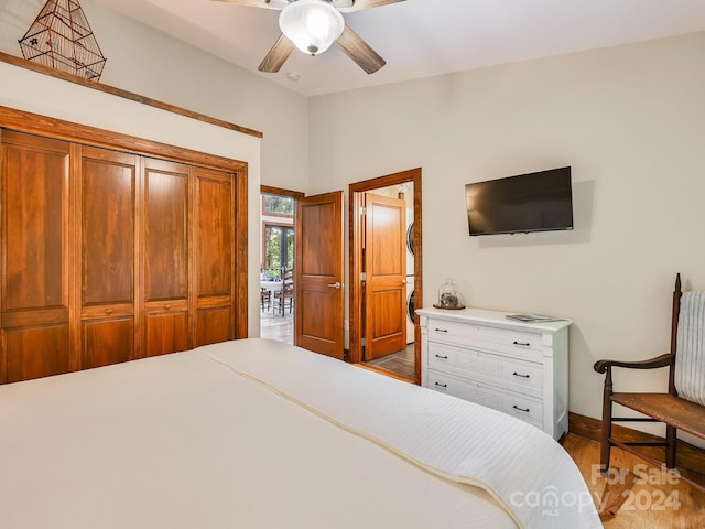 bedroom with ceiling fan, a closet, and light hardwood / wood-style flooring