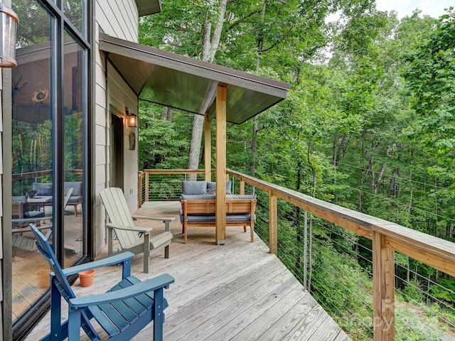 wooden terrace with an outdoor hangout area