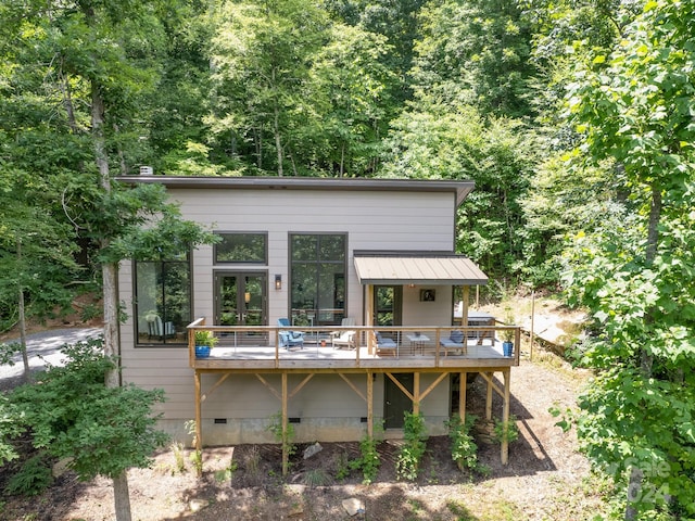 exterior space featuring a wooden deck and french doors