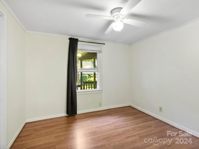 spare room with crown molding, ceiling fan, and hardwood / wood-style floors