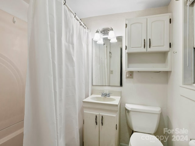 bathroom with vanity, toilet, and a shower with shower curtain