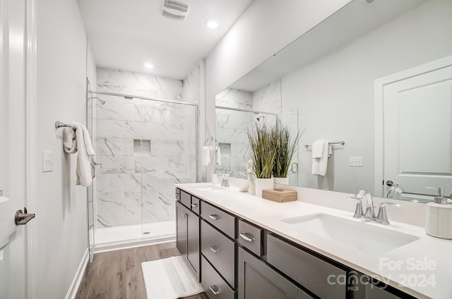 bathroom featuring vanity, hardwood / wood-style floors, and walk in shower