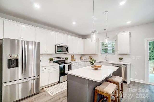 kitchen featuring a center island, white cabinetry, plenty of natural light, and stainless steel appliances