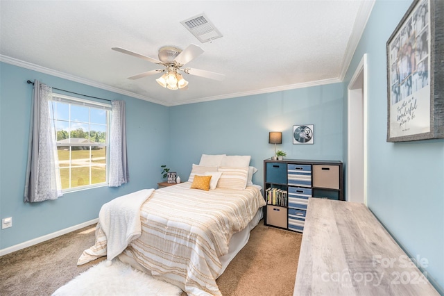 carpeted bedroom with ceiling fan and ornamental molding