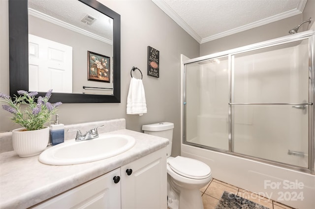 full bathroom featuring vanity, tile patterned floors, bath / shower combo with glass door, toilet, and a textured ceiling