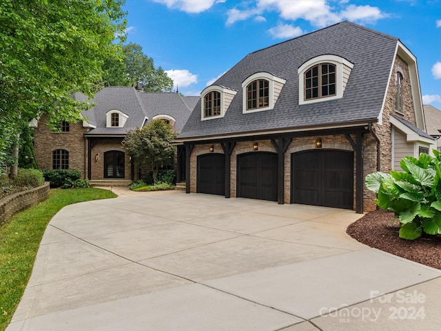 french country style house with a garage