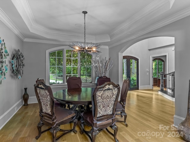 dining room with french doors, a tray ceiling, crown molding, and a notable chandelier