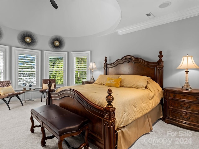 bedroom featuring ceiling fan, light colored carpet, and ornamental molding