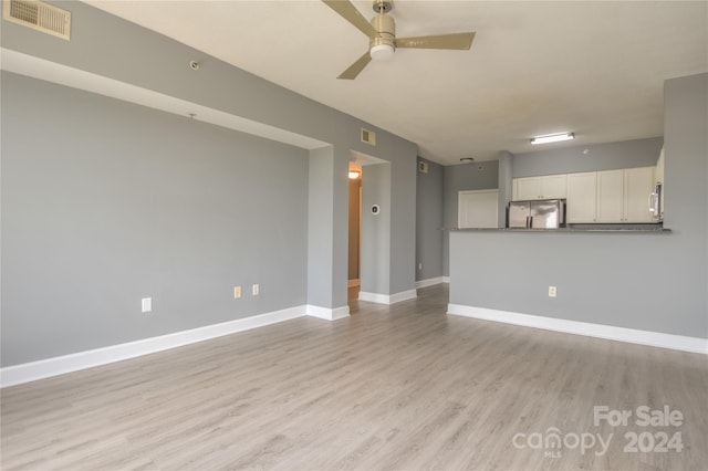 unfurnished living room featuring light wood-type flooring and ceiling fan