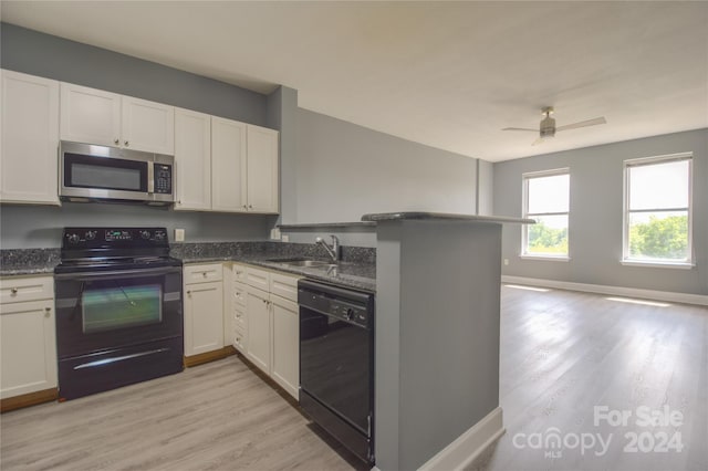 kitchen with black appliances, light hardwood / wood-style flooring, kitchen peninsula, and ceiling fan