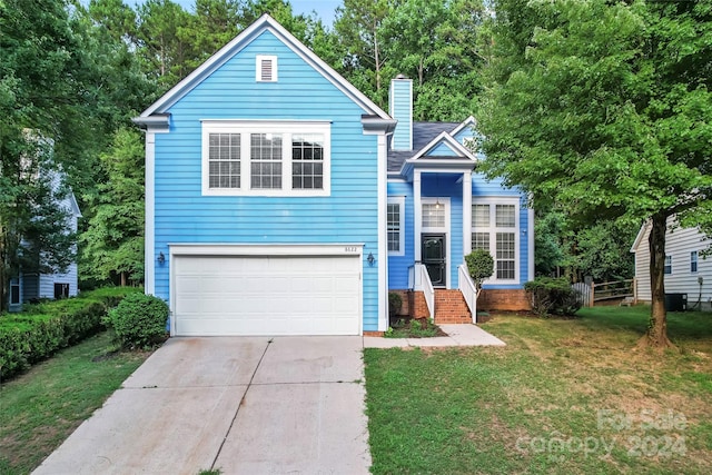 view of front of house featuring a garage and a front lawn