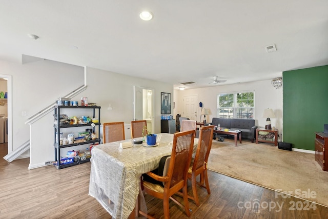 dining area with light hardwood / wood-style floors and ceiling fan