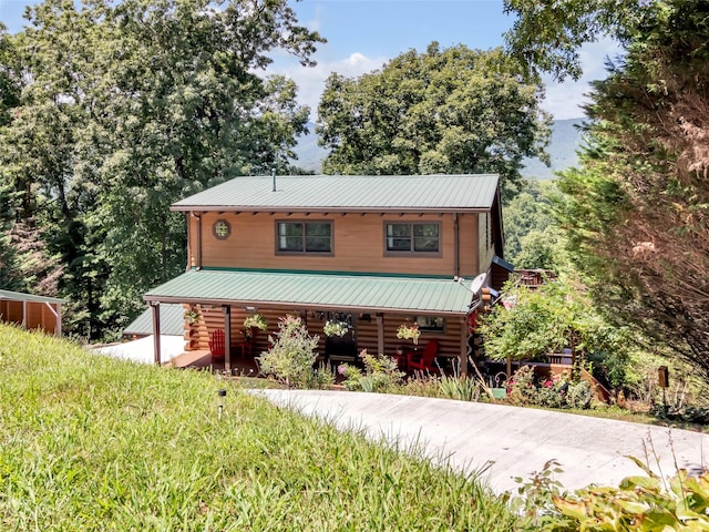 log-style house featuring metal roof