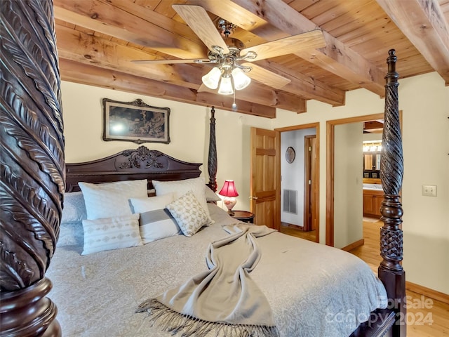 bedroom with beam ceiling, connected bathroom, hardwood / wood-style floors, ceiling fan, and wooden ceiling