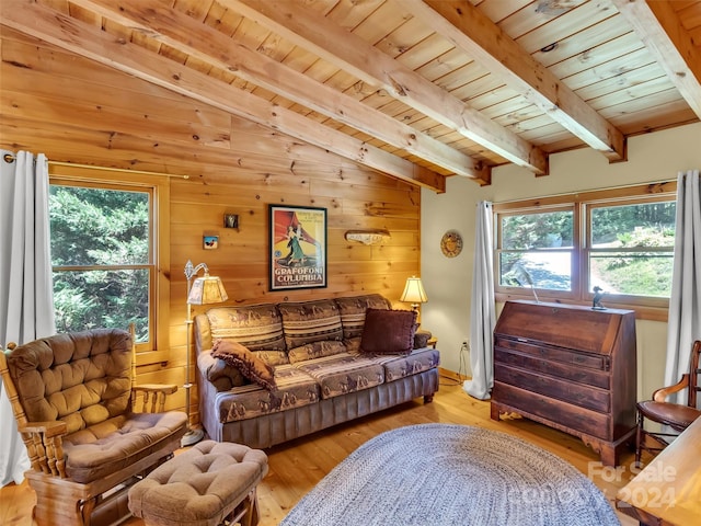 living room with vaulted ceiling with beams, light wood-type flooring, wooden walls, and wood ceiling