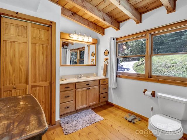 bathroom featuring hardwood / wood-style floors, wood ceiling, a closet, and beamed ceiling