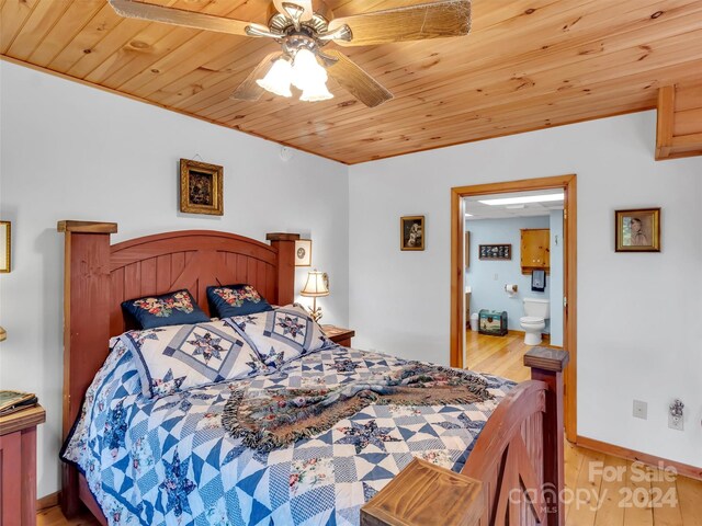 bedroom featuring baseboards, wooden ceiling, ceiling fan, wood finished floors, and ensuite bathroom