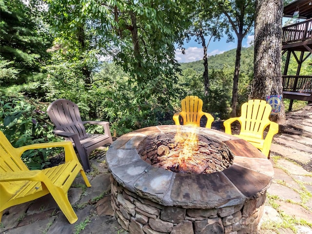 view of patio featuring a deck and an outdoor fire pit