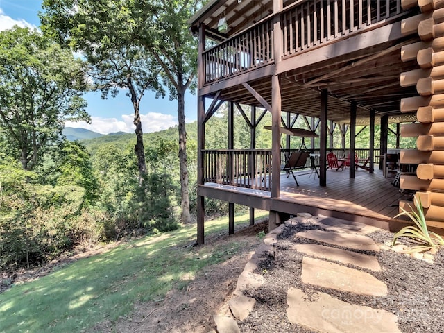 view of yard featuring a deck with mountain view