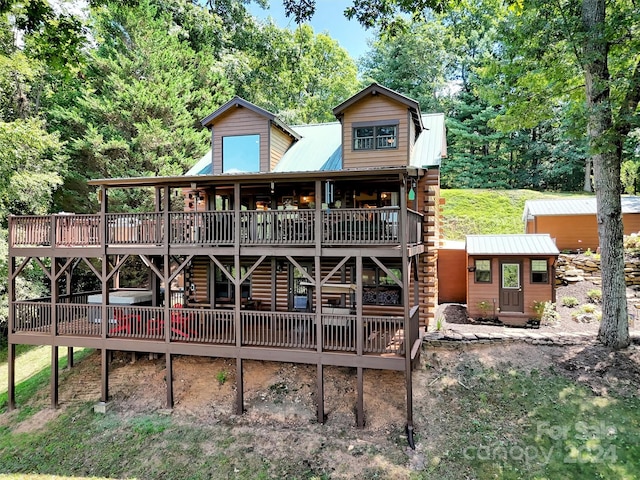 rear view of house featuring a wooden deck