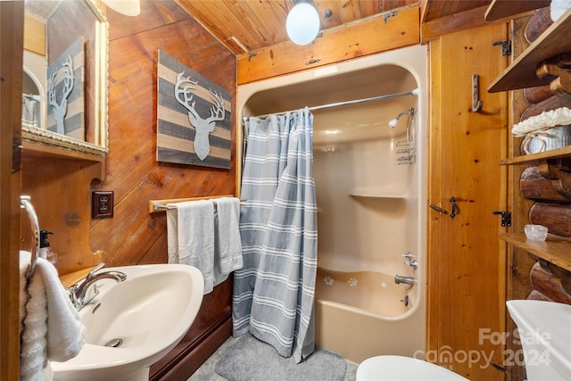 full bathroom featuring toilet, wood walls, sink, shower / tub combo with curtain, and wooden ceiling