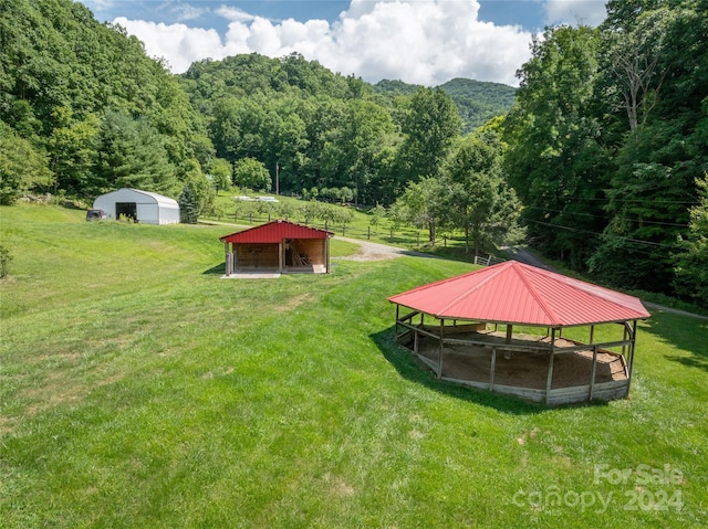 view of property's community with an outbuilding and a lawn