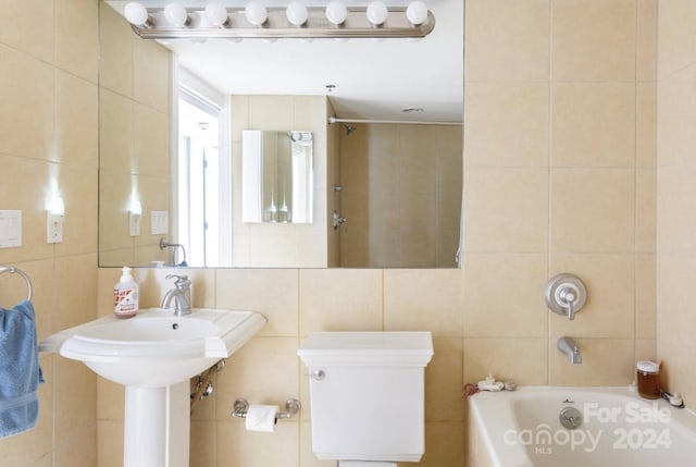 bathroom with tile walls and a bath