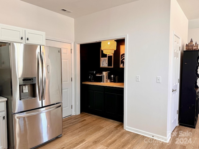 kitchen featuring white cabinets, stainless steel refrigerator with ice dispenser, and light hardwood / wood-style floors