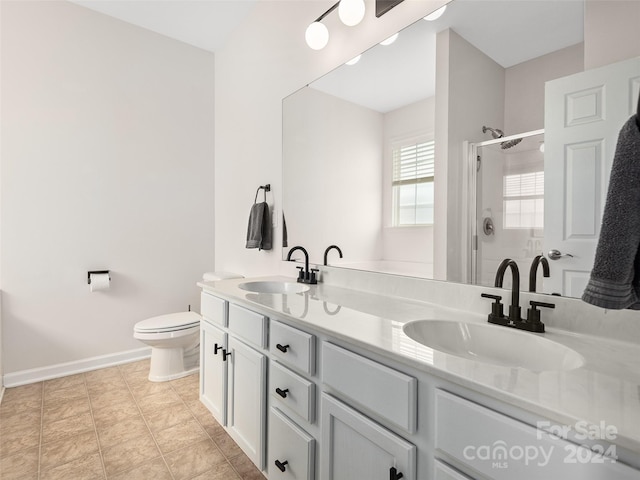 bathroom with toilet, vanity, tile patterned flooring, and a shower with door