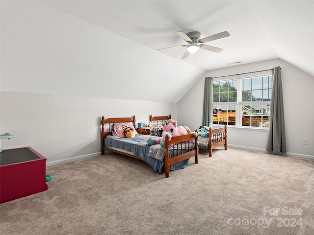 carpeted bedroom with ceiling fan and vaulted ceiling