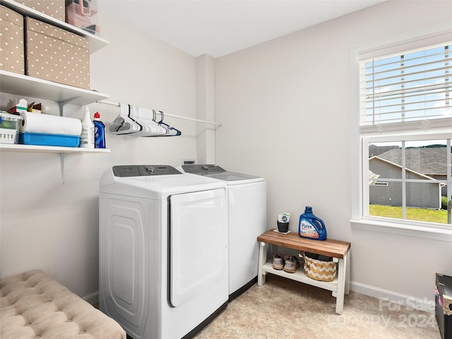 laundry area featuring a healthy amount of sunlight and washing machine and clothes dryer