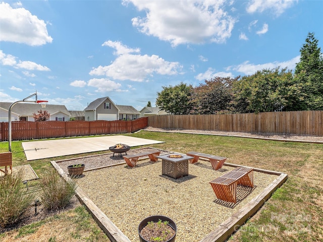 view of yard featuring a patio area and an outdoor fire pit