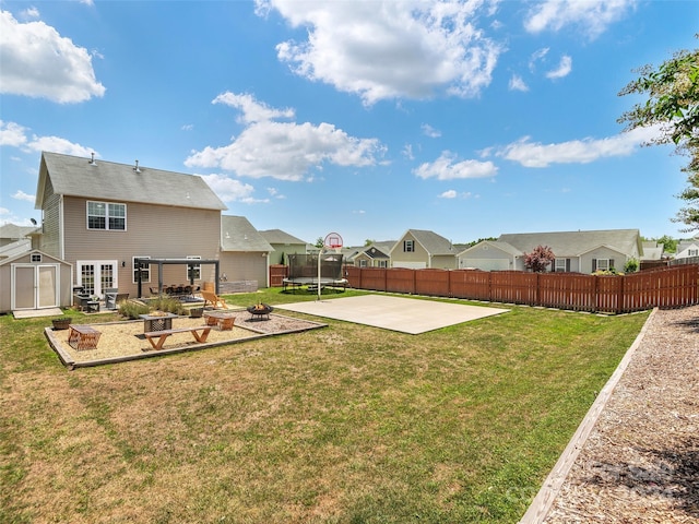 view of yard with a trampoline and a patio