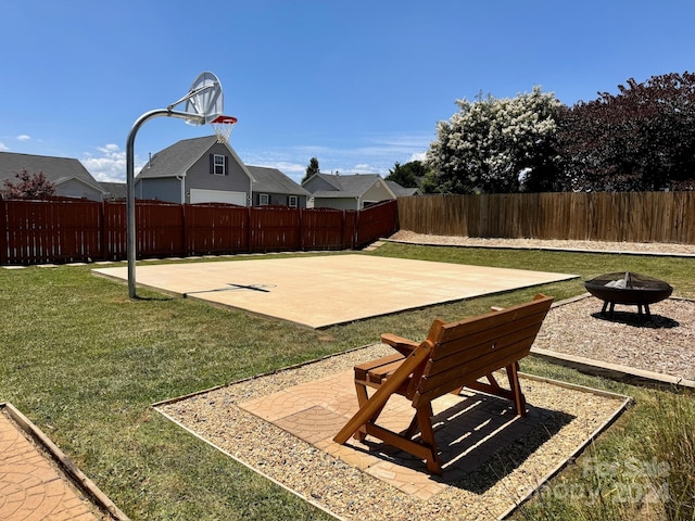 exterior space featuring basketball court and an outdoor fire pit