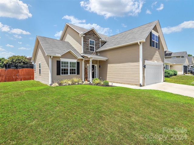 view of front of house with a front yard and a garage