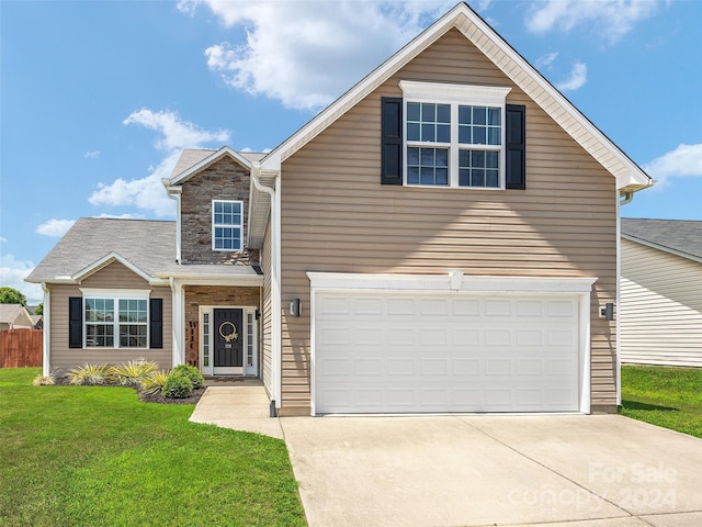 front facade featuring a front yard and a garage