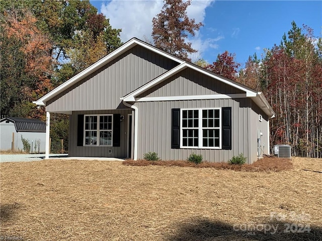 view of front of property featuring a storage shed and cooling unit