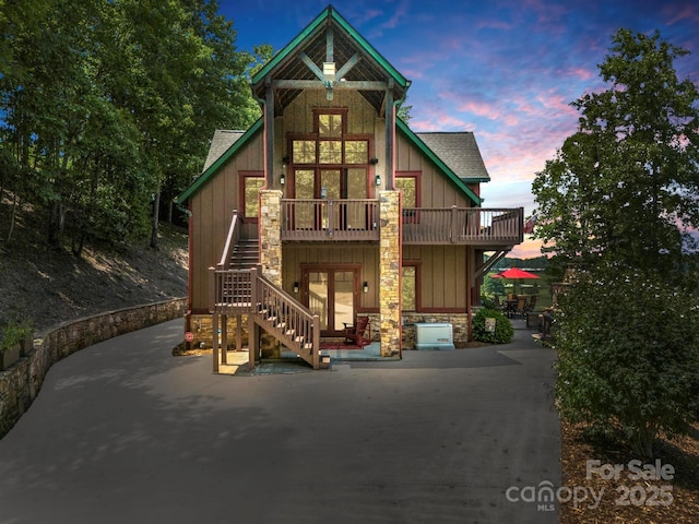 craftsman-style house featuring a patio and a balcony