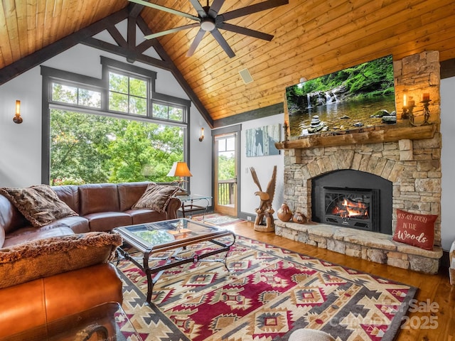 living room featuring ceiling fan, high vaulted ceiling, wood-type flooring, a fireplace, and wood ceiling