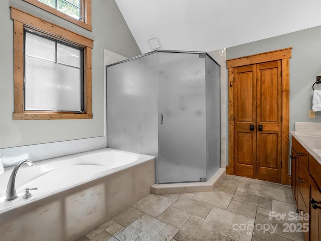 bathroom with plus walk in shower, vanity, and vaulted ceiling