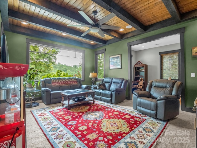 living room featuring beam ceiling, ceiling fan, carpet, and wood ceiling