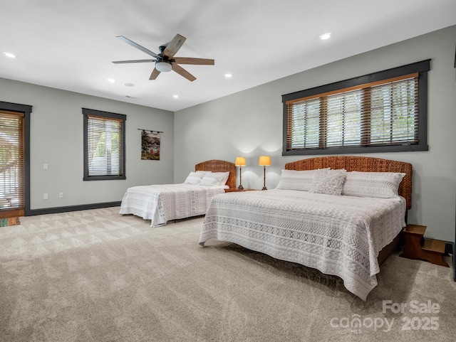 bedroom featuring ceiling fan and light colored carpet