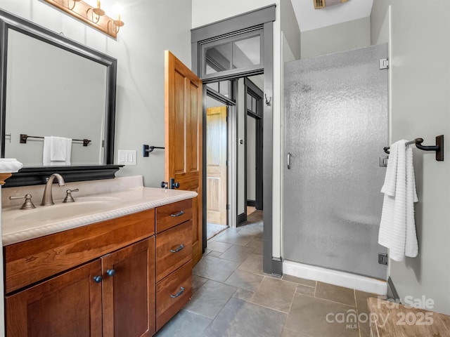 bathroom featuring vanity and a shower with shower door