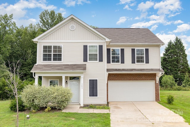 view of front of home featuring a garage and a front lawn