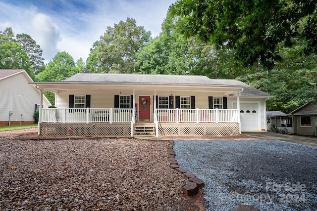 ranch-style home featuring a garage and covered porch